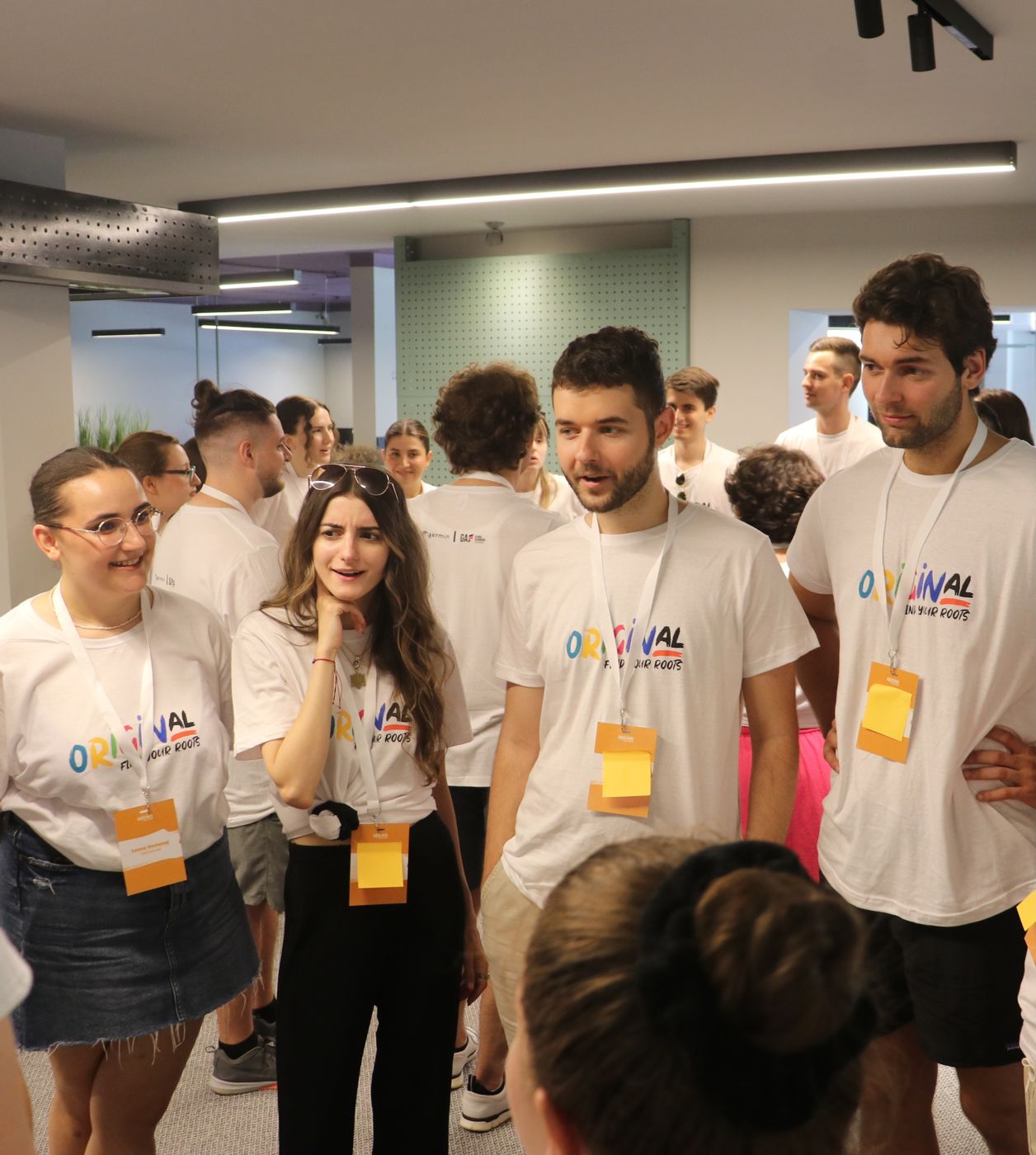 OriginAL participants in program shirts during a workshop visit